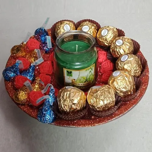Elegant Plate Circled with Chocolates, Scented Candle N Decorative Flowers