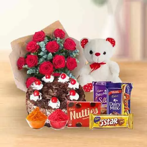 Awesome bouquet of  Roses with a delicious Cake, mixed Cadburys Chocolate and lovely Teddy Bear