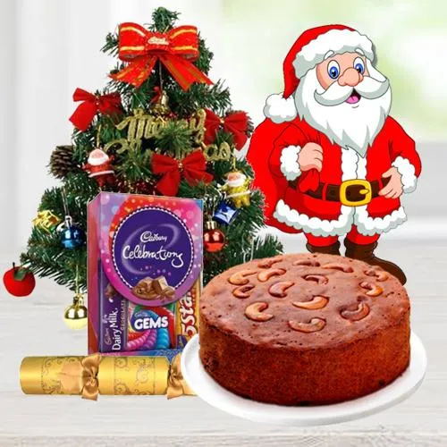 Christmas Fruit Cake 1 Lbs. with Christmas Tree 1 Ft. long artificial, Assorted Cadbury”s Chocolates for hanging ( 130 G.), Star and Bells for decoration, Santa Claus and  Handheld Ribbon Crackers for Christmas