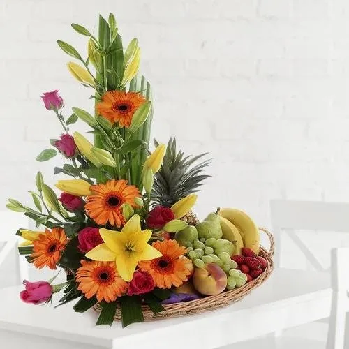 Send Basket full of assorted fruits and flowers for dear mom