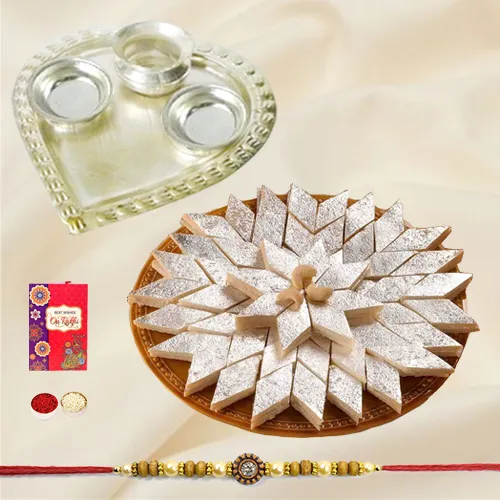 Delicious Kaju Katli and Stylish and Trendy looking Silver Plated Paan Shaped Puja Aarti Thali along Rakhi, Roli, Tilak and Chawal