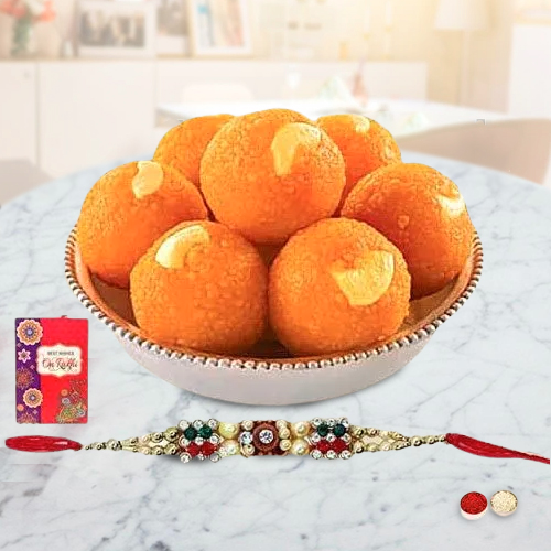 A Free Decorative Rakhi Roli Tilak and Chawal with Haldiram Pure Ghee Ladoo