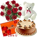 12 Exclusive  Dutch Red   Roses  Bouquet with Cake , Cadburys Assorted Chocolates and  a Cute Teddy Bear<br/><font color=